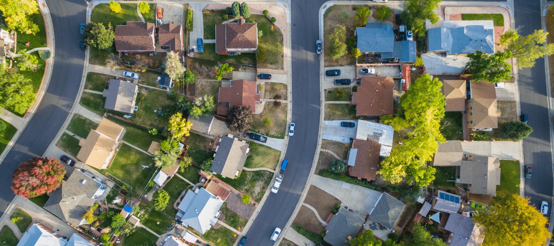 Aerial view of a suburban neighborhood with curved streets and green lawns